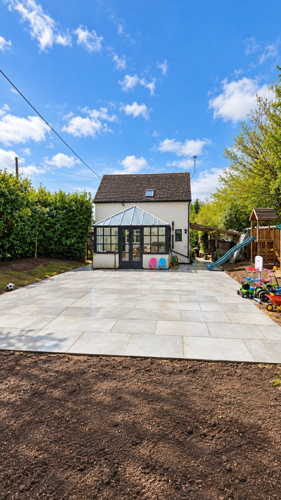 New patio installation with sandstone paving in a family garden